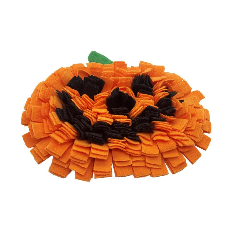 Orange pumpkin-shaped pet smell mat on flat surface showing polar fleece texture