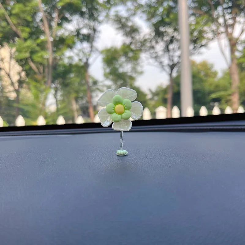 Small colourful plastic swing decoration for car interior, approx. 5cm tall.