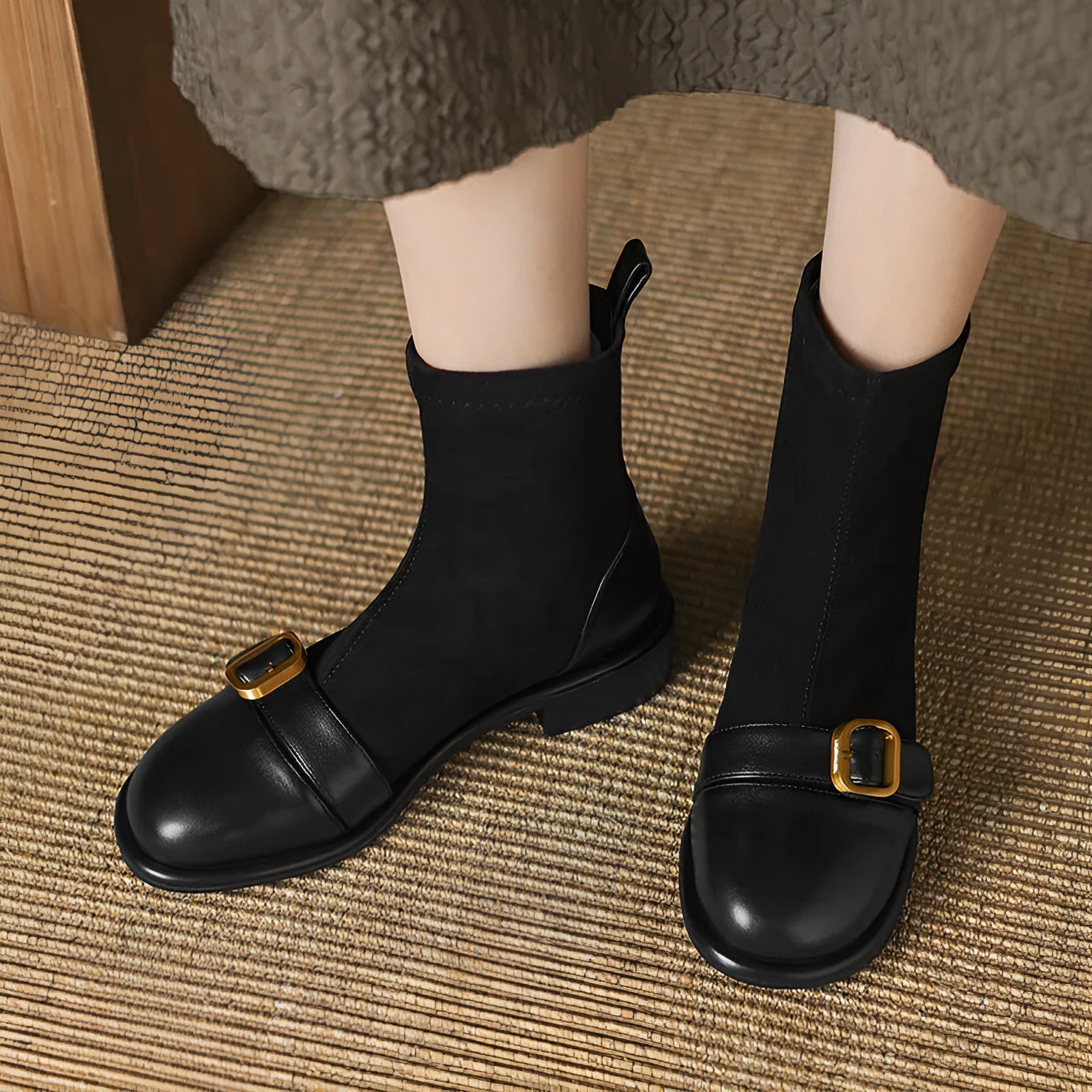 Women's black low heel Martin boots with lace-up front and belt buckle stitching detail on a round toe.