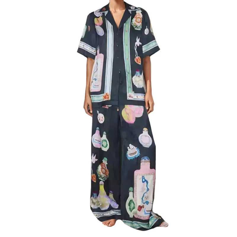 Black women's casual set with cartoon print, featuring sleeveless cardigan and trousers.