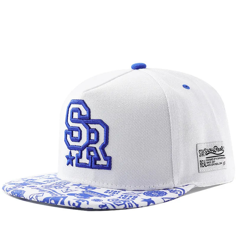 Black and white cotton baseball cap with letter embroidery on the front, showing adjustable strap.
