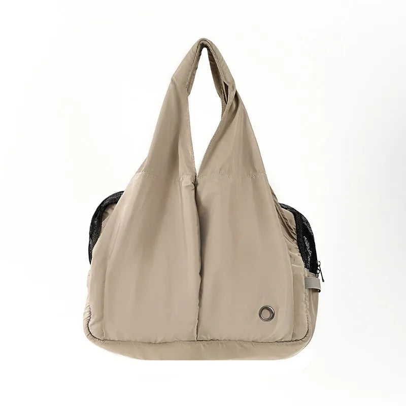 Apricot-colour cloth pet carrier handbag for small pets, showing single handle and rectangular shape.