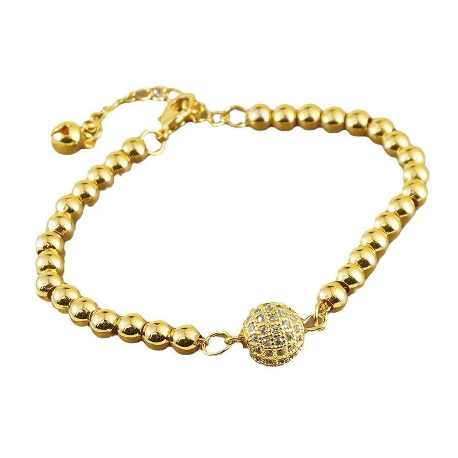 Copper bracelet with heart-shaped Arabic design and single zircon centrepiece on white background