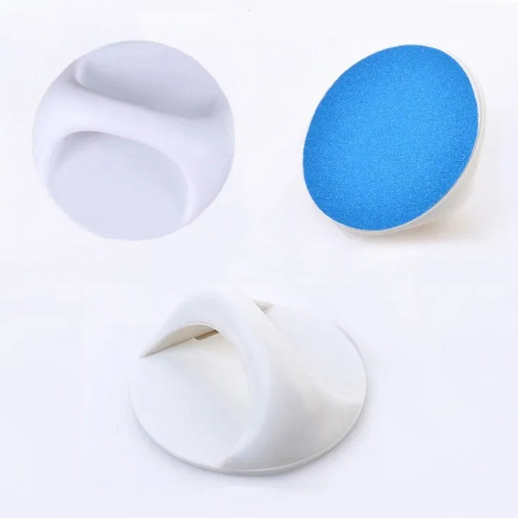 Round blue dog nail file board with ergonomic handle on a table.