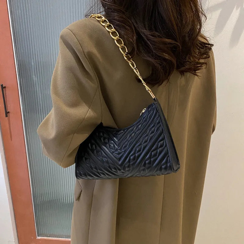 Brown pleated chain strap baguette shoulder bag with a vertical square shape and soft carry handle.
