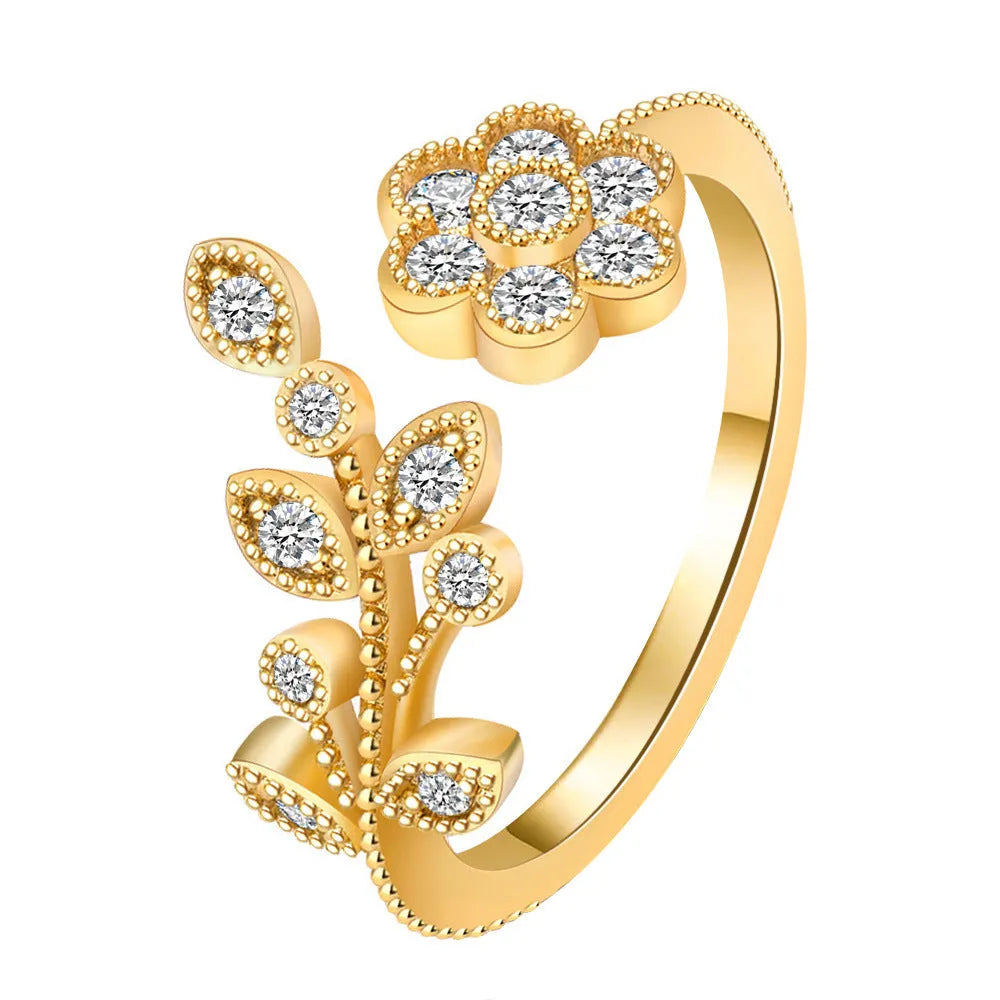 Women's open ring with flower and leaf design on a copper base with a diamond finish.