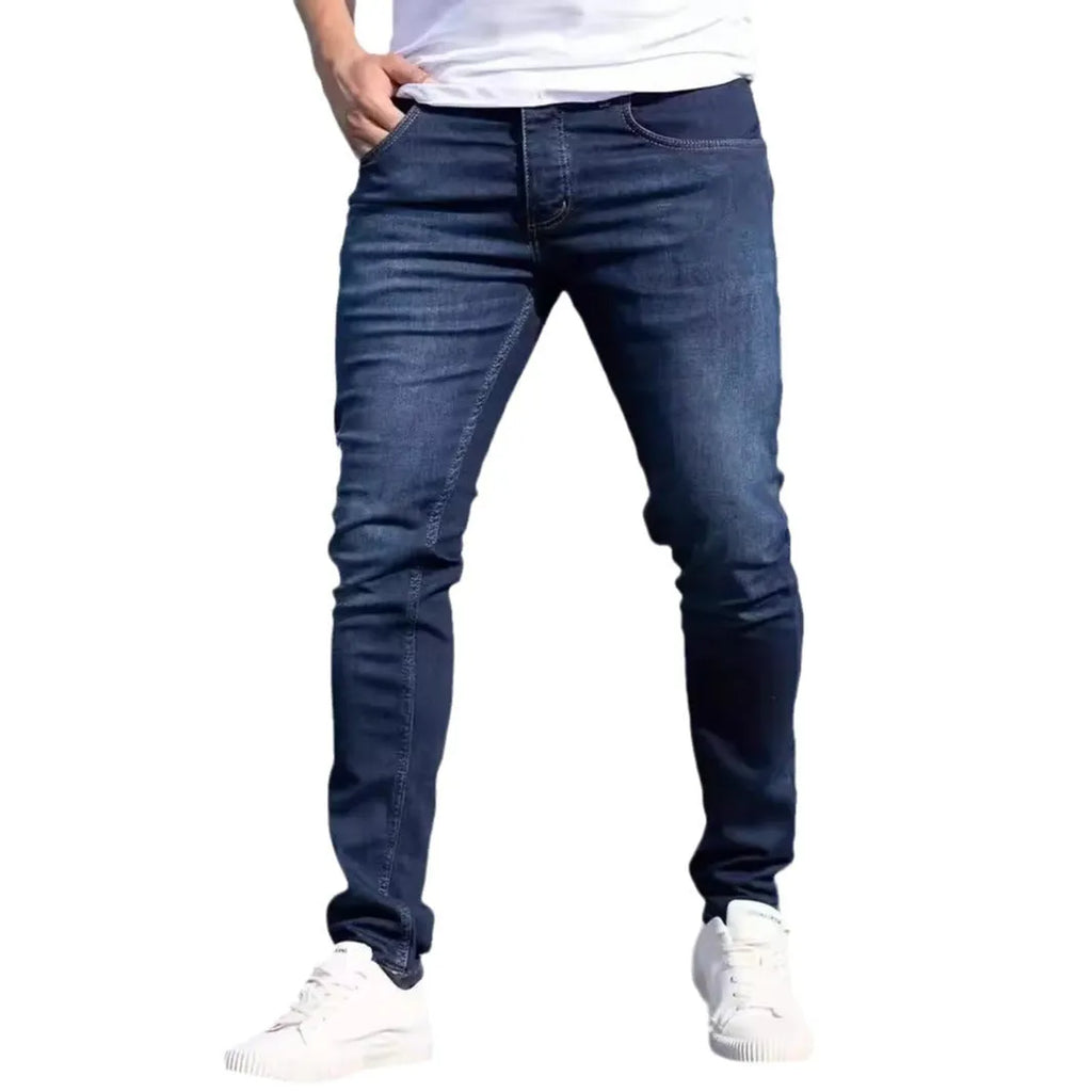Men's dark blue slim fit casual jeans with skinny leg cut and zipper fly closure
