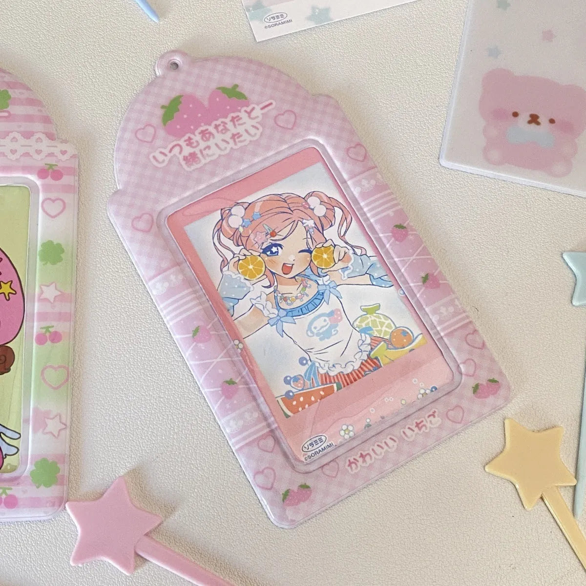 Cartoon strawberry or four-leaf clover PVC card holder measuring 7.6 by 13.6 centimetres.