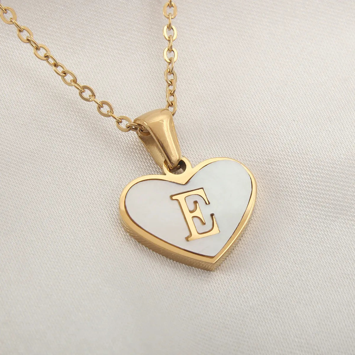Gold plated heart necklace with white shell detail on an adjustable chain