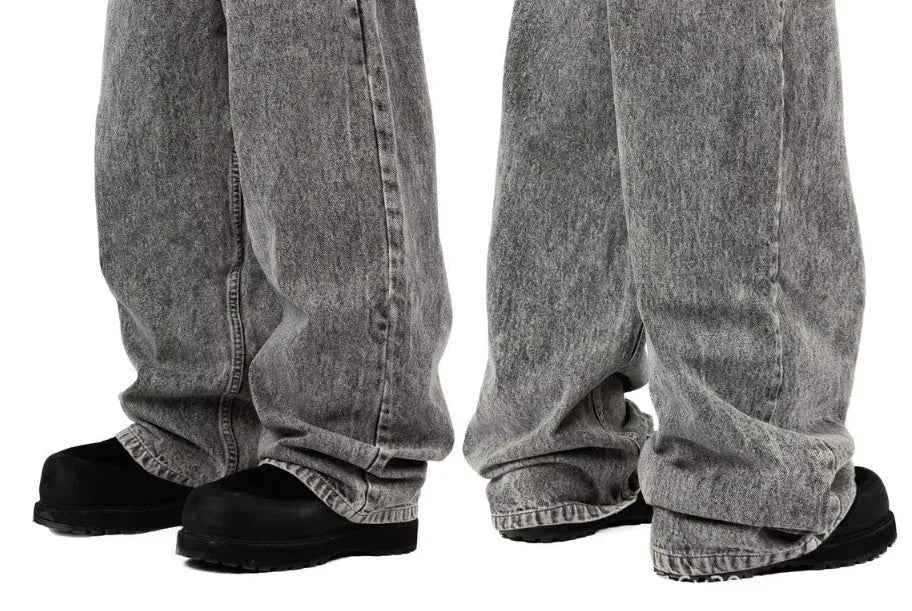 Grey loose straight-leg cotton denim trousers on a hanger, showing mid waist and straight leg cut.