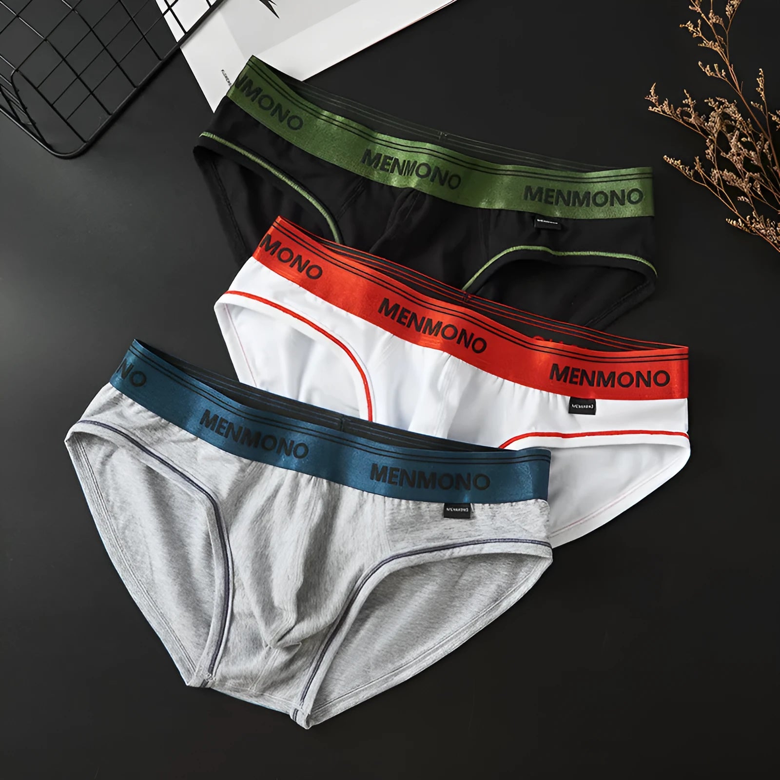 Men's solid colour cotton low waist briefs on a white background.