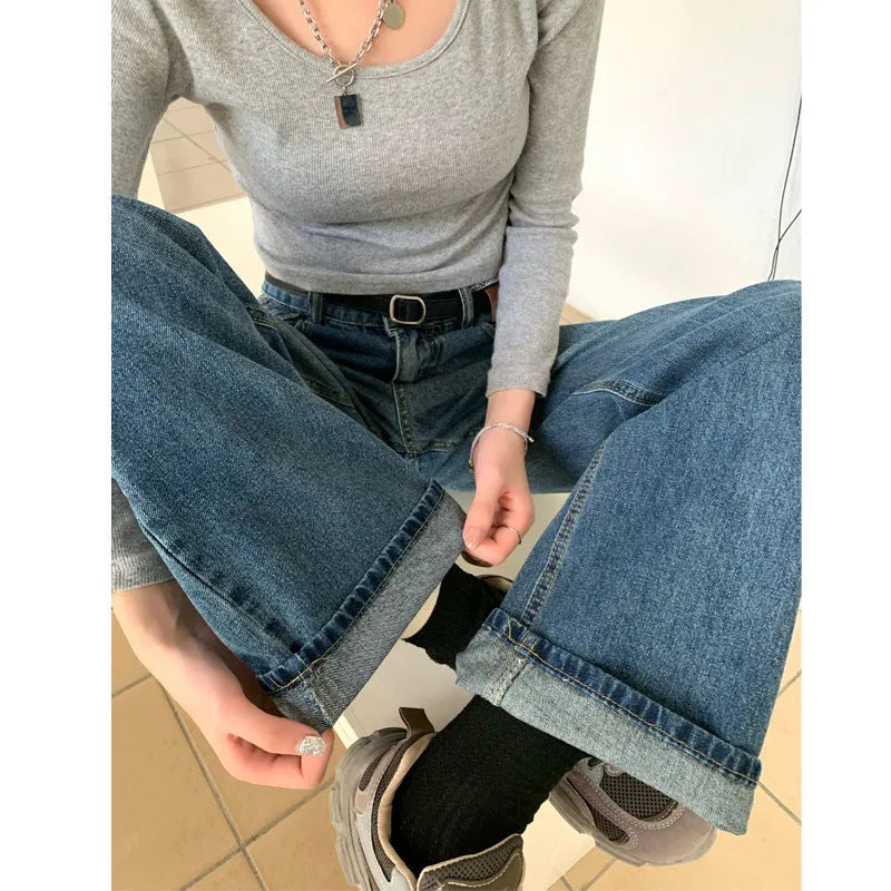 Women's high-waist retro blue straight-leg jeans on a model, showing the classic fit.