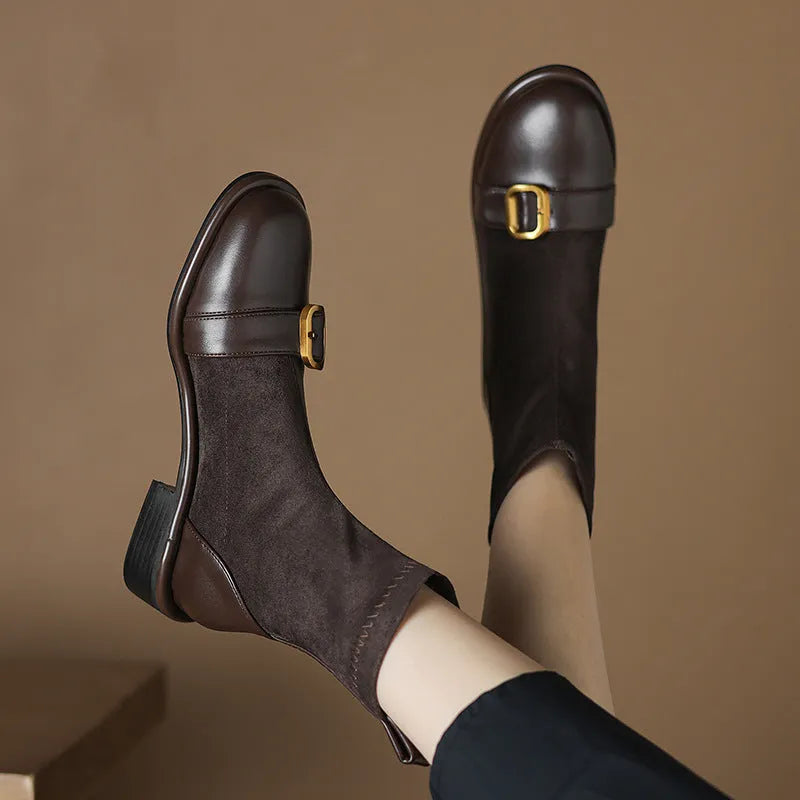 Women's black low heel Martin boots with lace-up front and belt buckle stitching detail on a round toe.