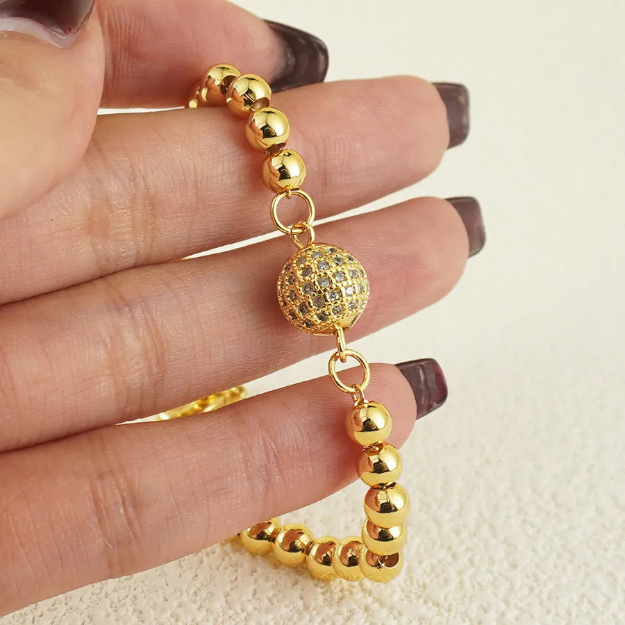 Copper bracelet with heart-shaped Arabic design and single zircon centrepiece on white background