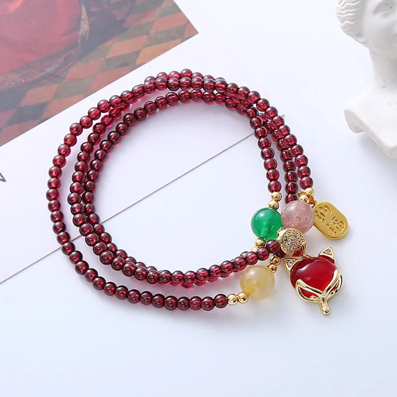 Purplish red garnet crystal fox charm bracelet with adjustable rope design