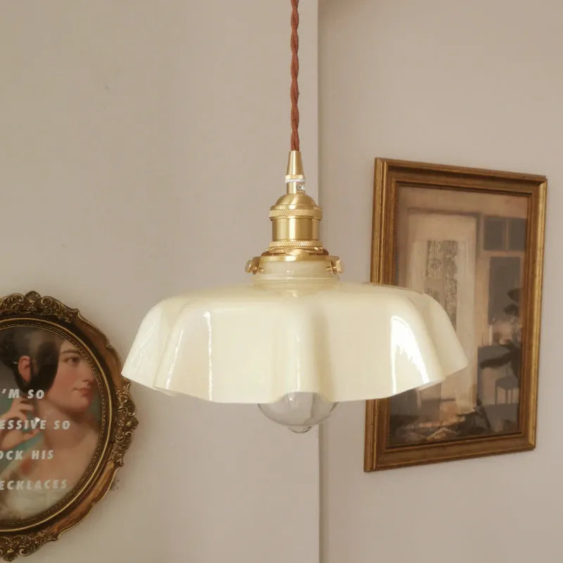 Medieval-style brass and cream glass chandelier light fitting with adjustable cord.