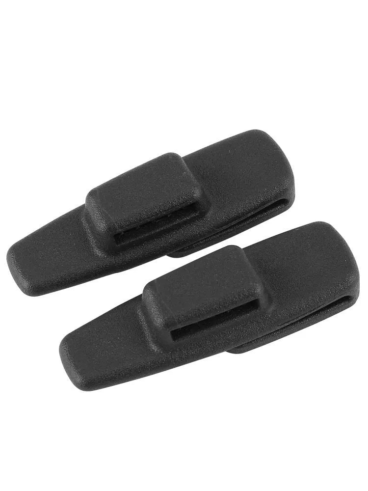 Two black ABS plastic car seatbelt stopper clips on clear OPP packaging.