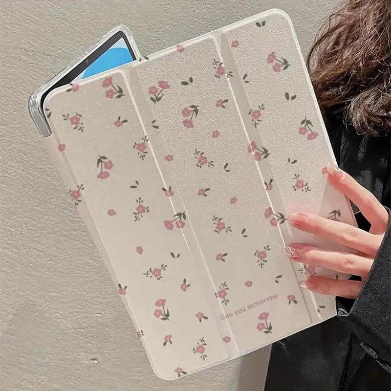 Transparent floral patterned tri-fold protective case for Apple iPad in stand position.