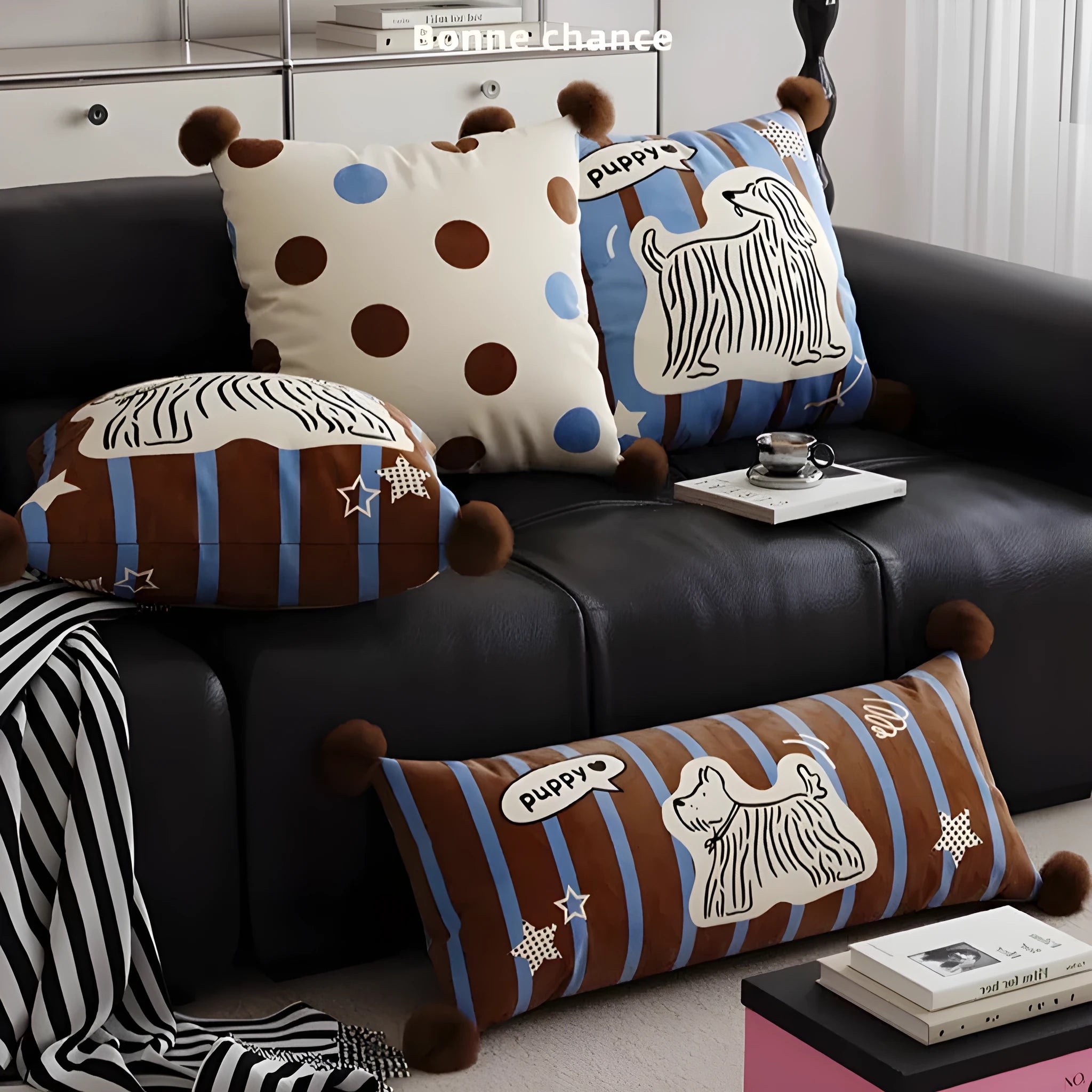 Blue cartoon animal print sofa cushion pillow on a sofa next to a brown one.