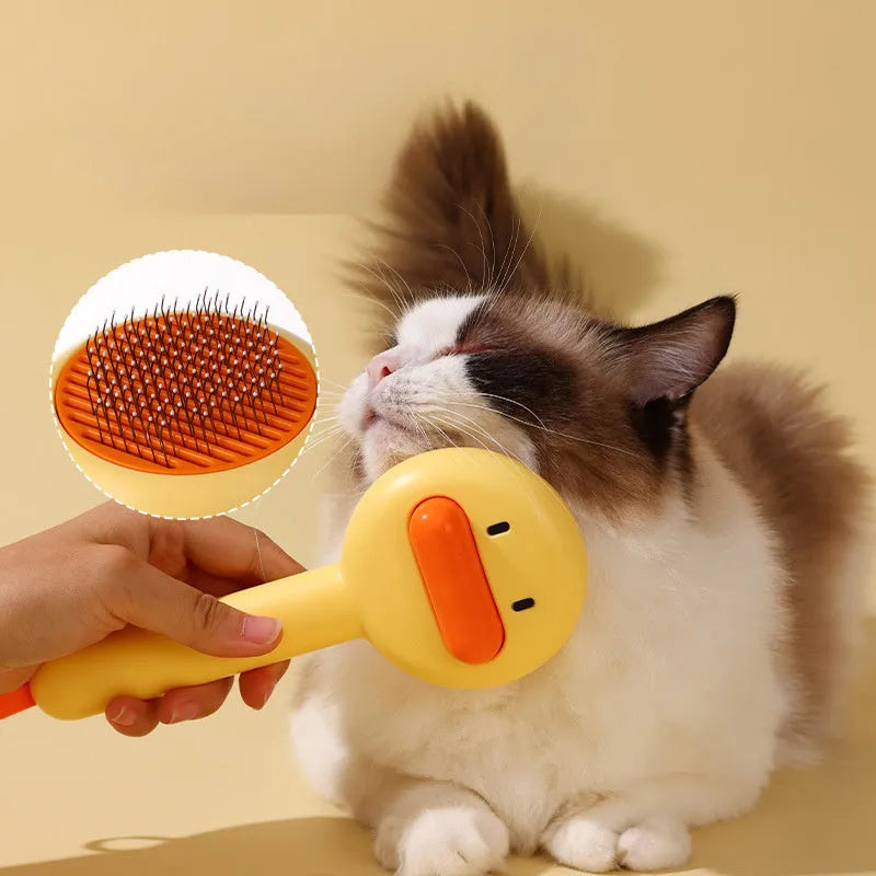 Small yellow duck-shaped pet comb with needle bristles for cat and dog grooming