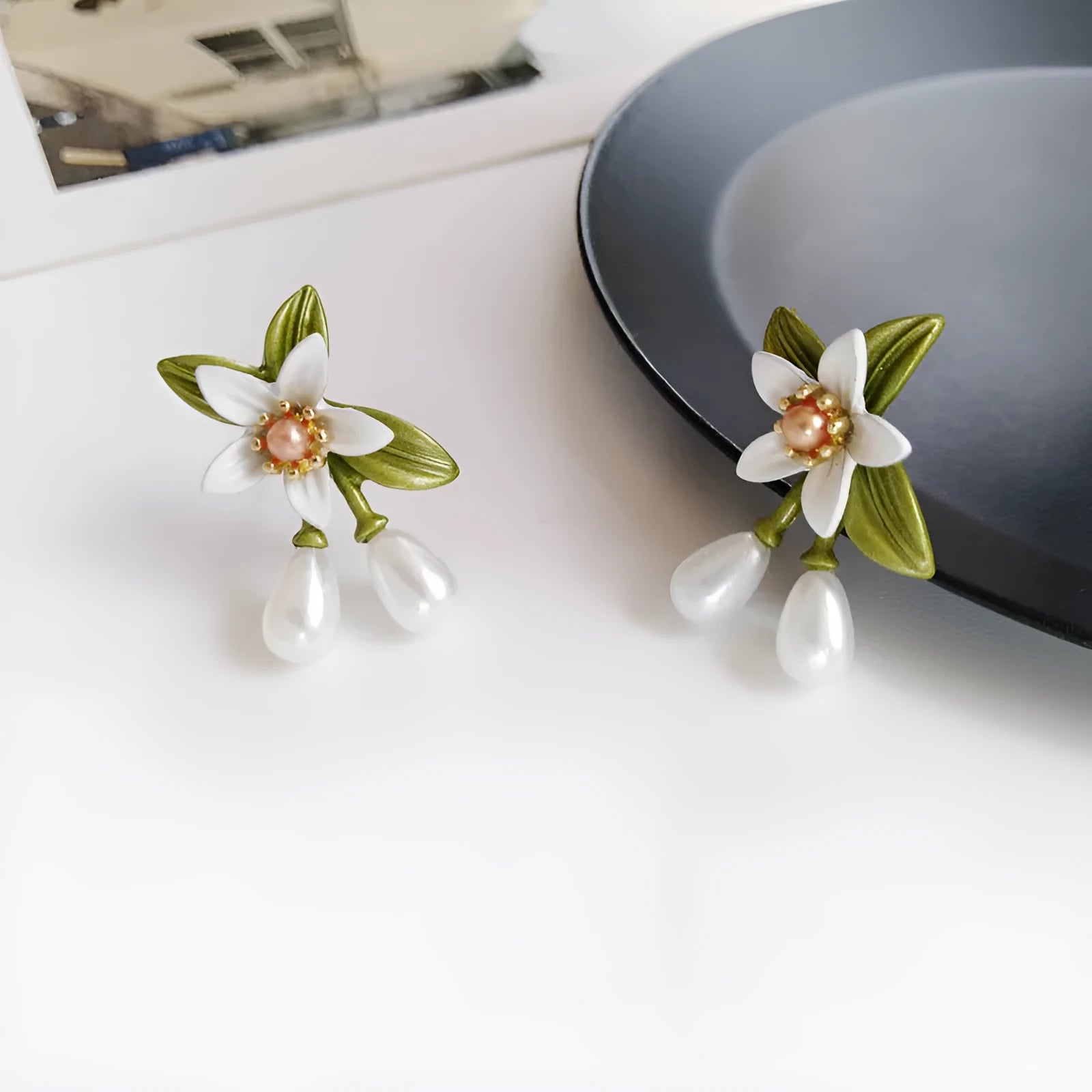 Alloy flower ear stud and matching clip-on earring pair with sterling silver needle camellia design.