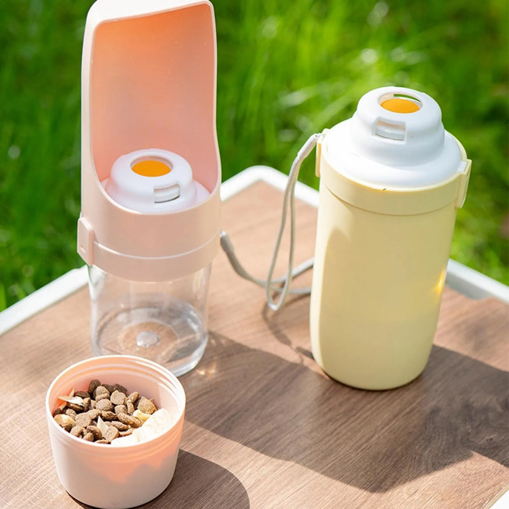 Grey foldable 2-in-1 dog water bottle and feeder with lanyard, showing food and water compartments.