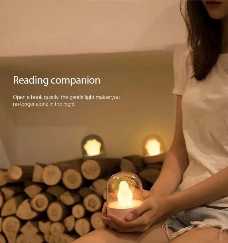 Grey or pink cat paw shaped night light with USB charging port and music box functionality