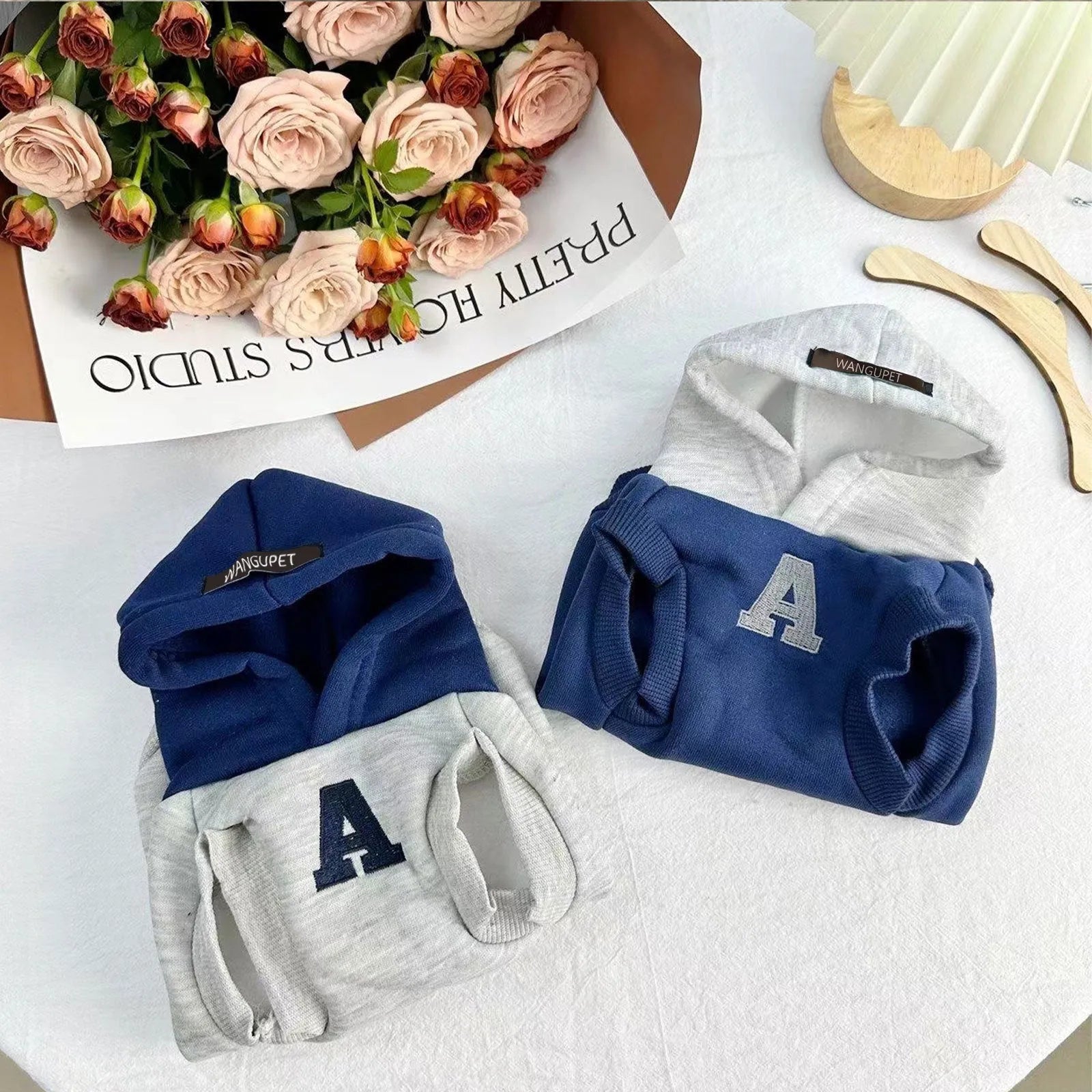 Blue and grey white slim-fit polyester hoodie for pets with reflective lettering on the back.