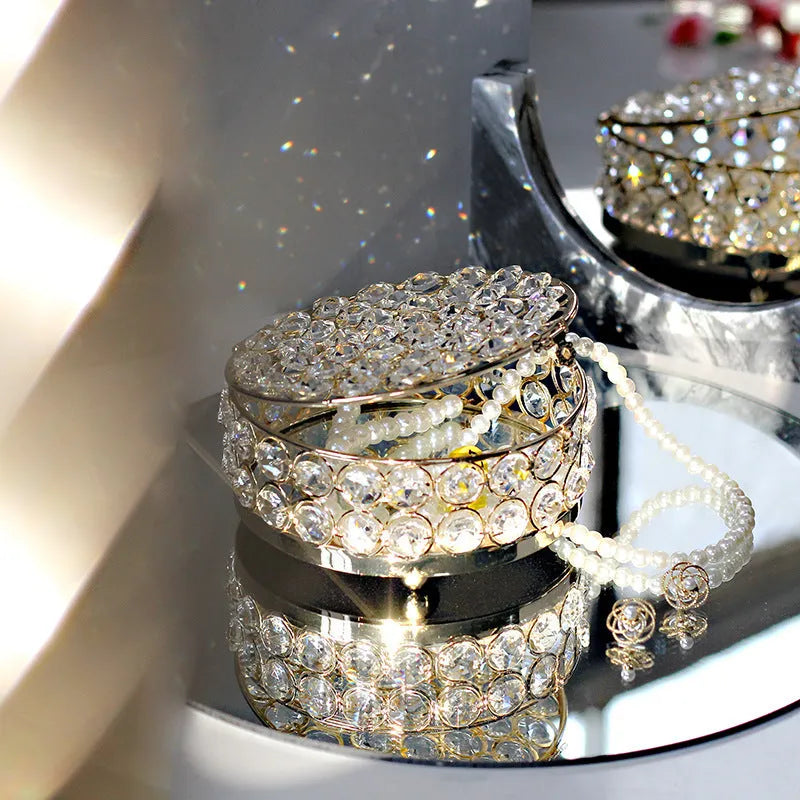 French gold metal jewelry box with a clear crystal glass front panel on display.