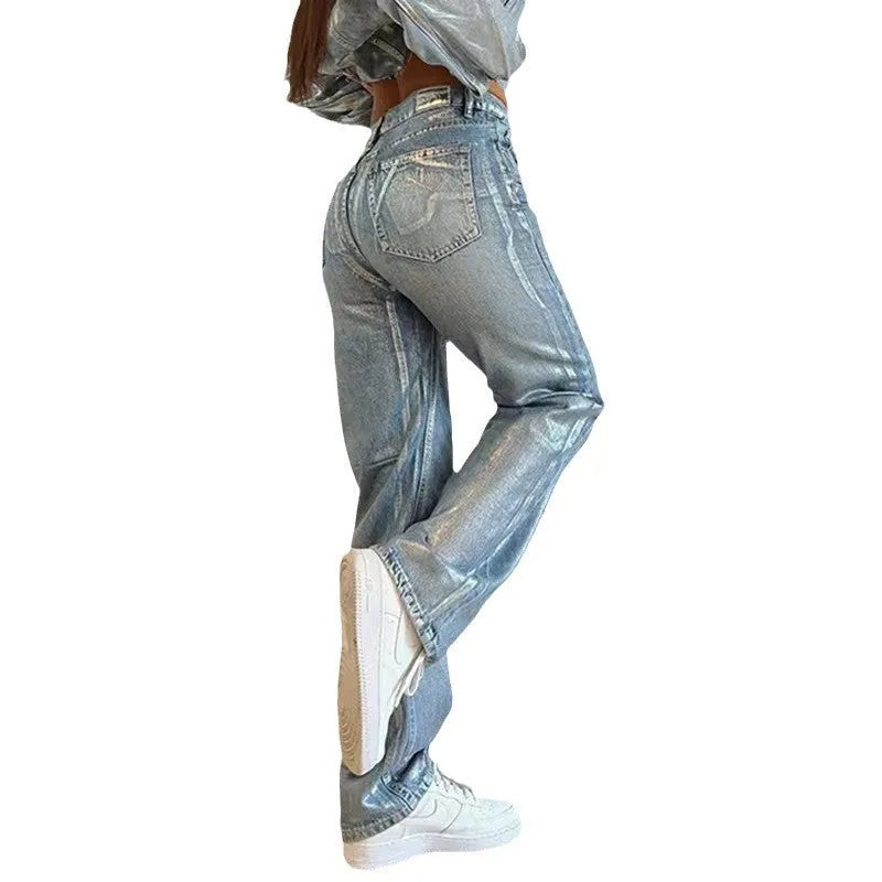 Washed blue high-waist straight-leg jeans with contrast colour detailing on a denim background.