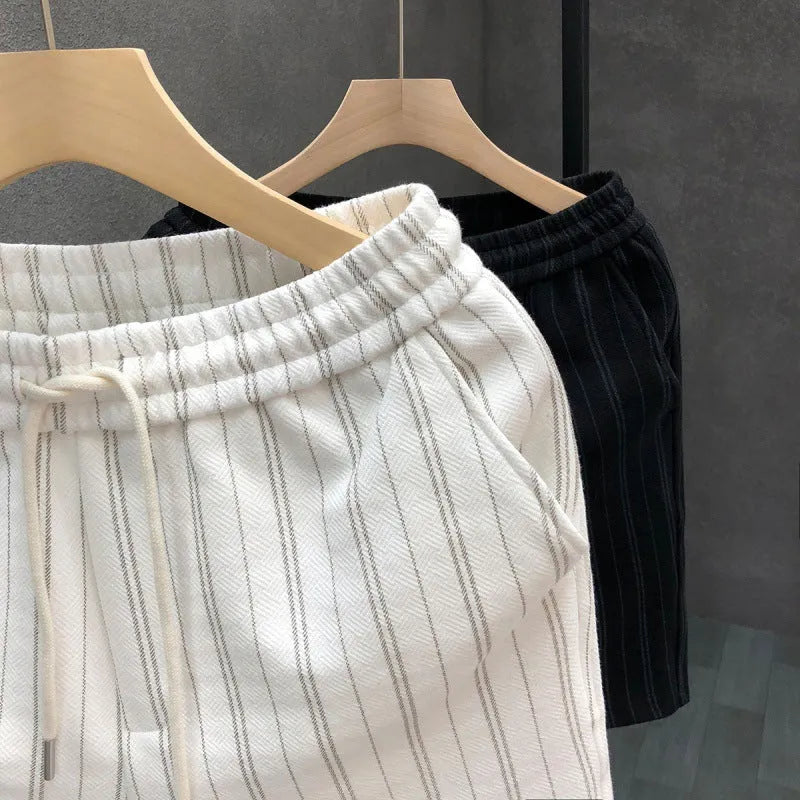 Men's black and white striped casual shorts with an ankle band and double-layer waistband.