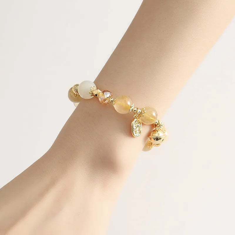 Gold rutilated quartz ringing bell bracelet with Korean style design and electroplated crystal construction