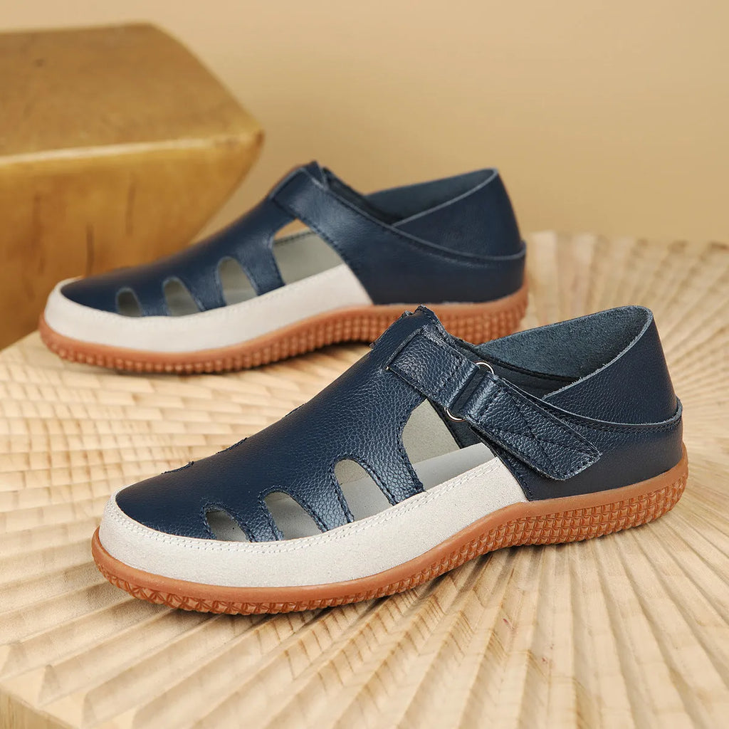 Women's flat sandals with hollow-out toe cap design in blue colour showing thick rubber sole