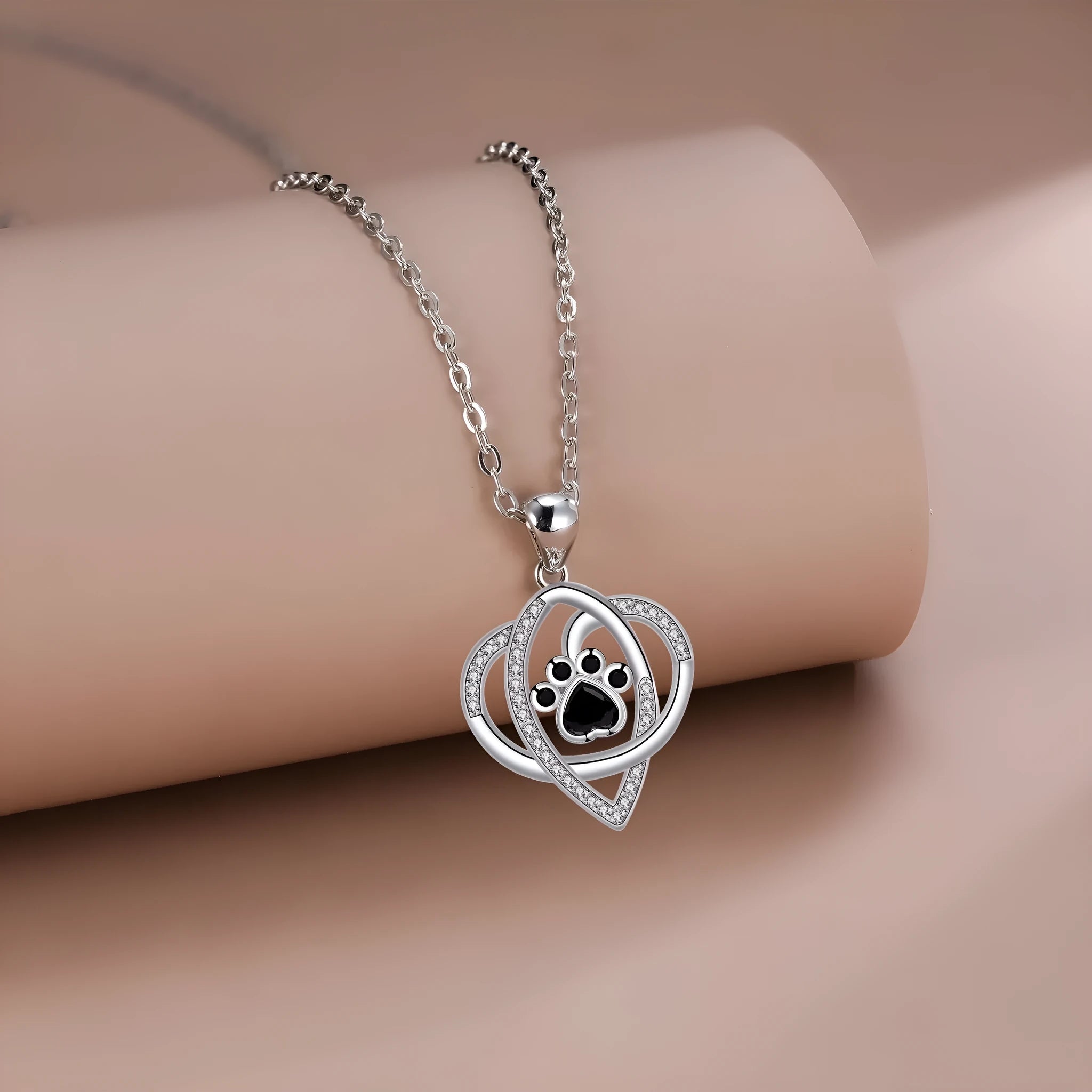 Silver tone necklace with cat and dog paw print pendant on cross chain for women