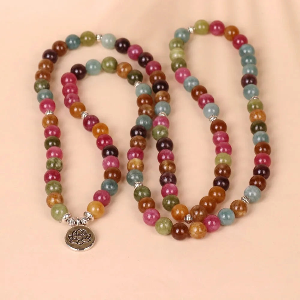 108-bead multi-layer alloy bracelet in a tourmaline colour, shown hanging and as worn jewellery.
