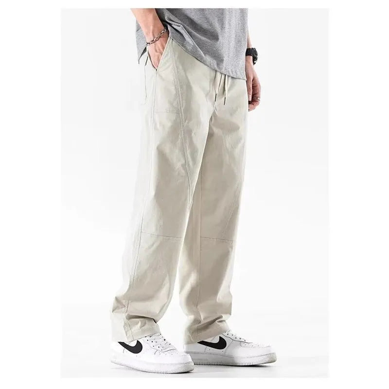 Women's milky white cotton wide-leg trousers with an elasticated waistband on a hanger.