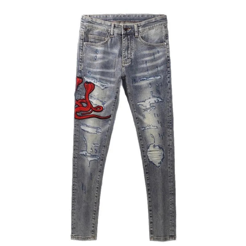 Slim fit jeans in washed-out old colour with patch embroidery detail on the leg.