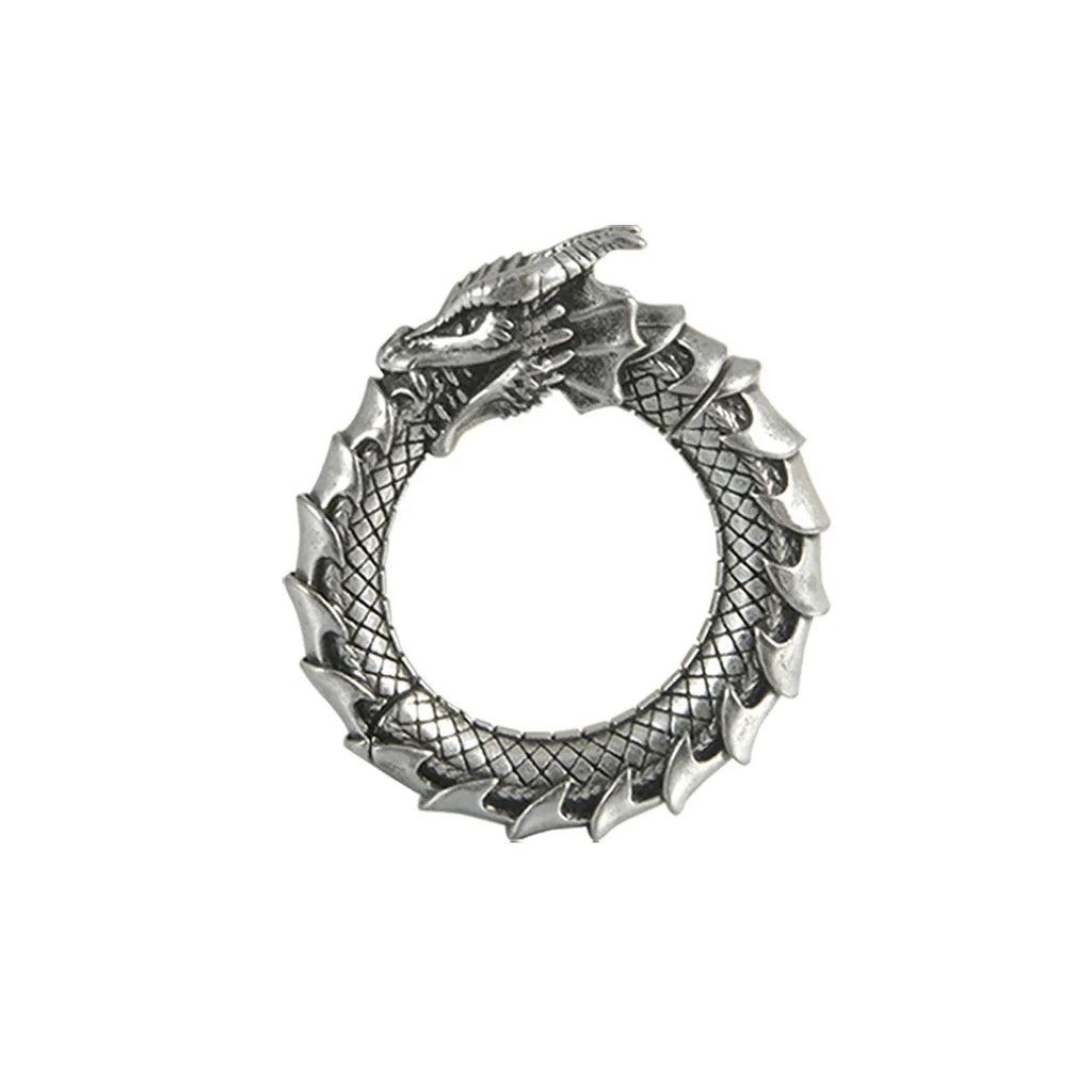 Large antique silver alloy earrings with a geometric hollow out dragon shape on a grey background.