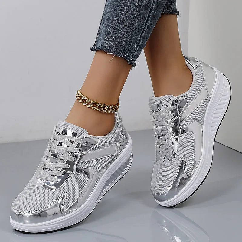 Women's gold patent leather mesh sports shoes with cross straps and platform sole.