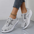 Women's gold patent leather mesh sports shoes with cross straps and platform sole.