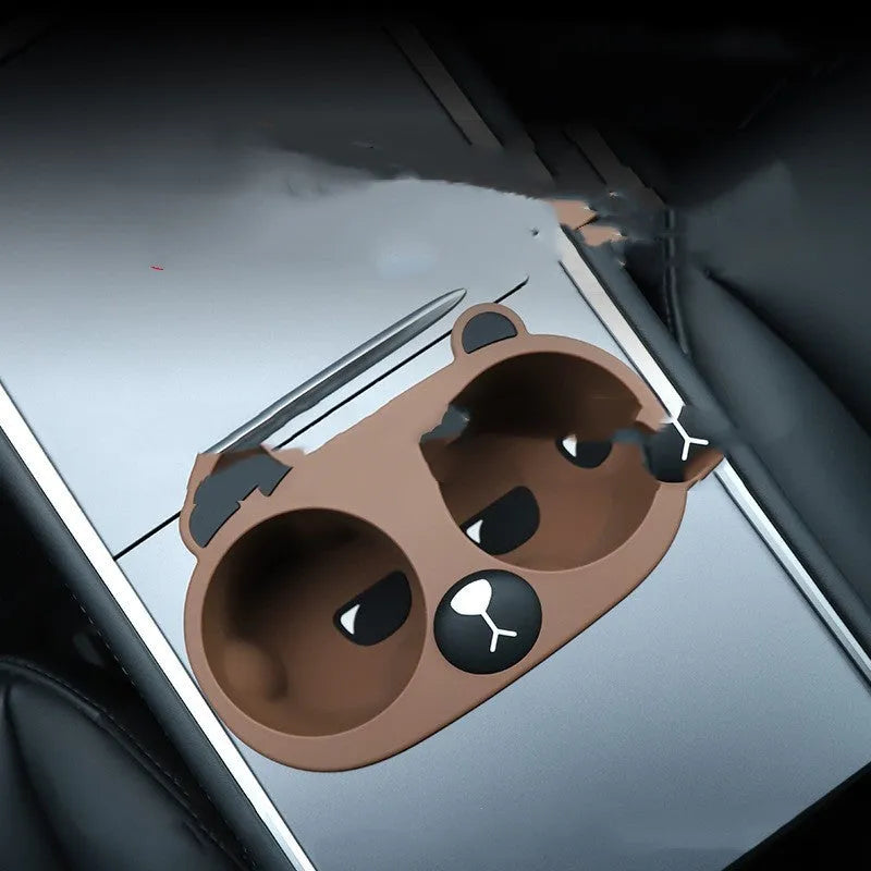 Grey silicone car centre console cup holder insert stabilising a drink