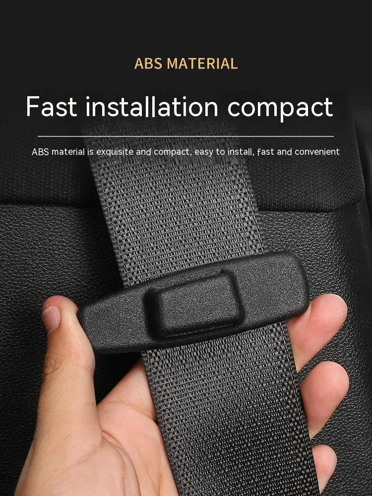 Two black ABS plastic car seatbelt stopper clips on clear OPP packaging.