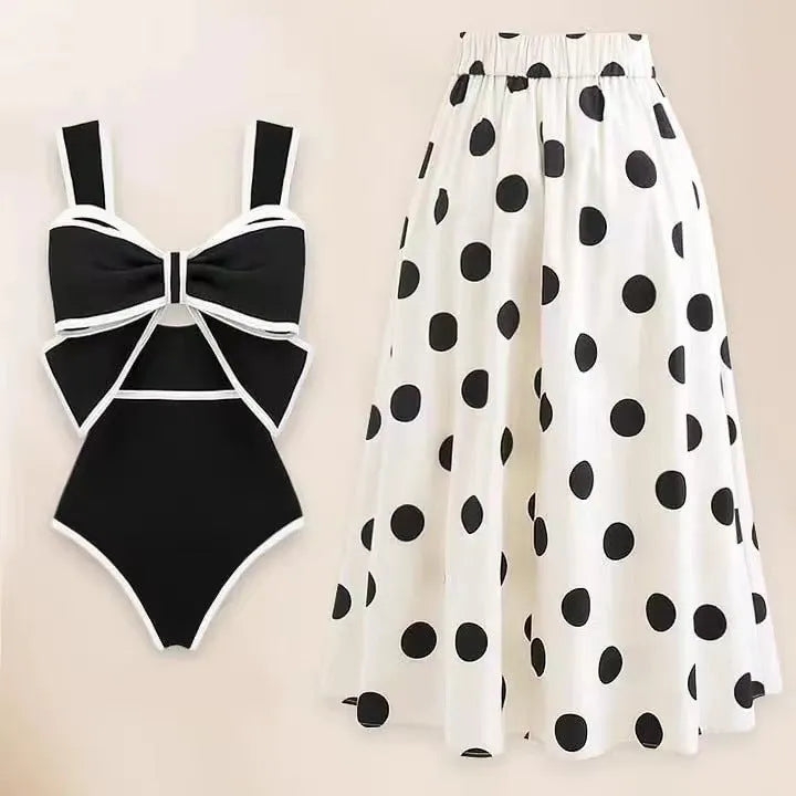 Women's black one-piece swimsuit with a white round skirt and a bow at the centre front