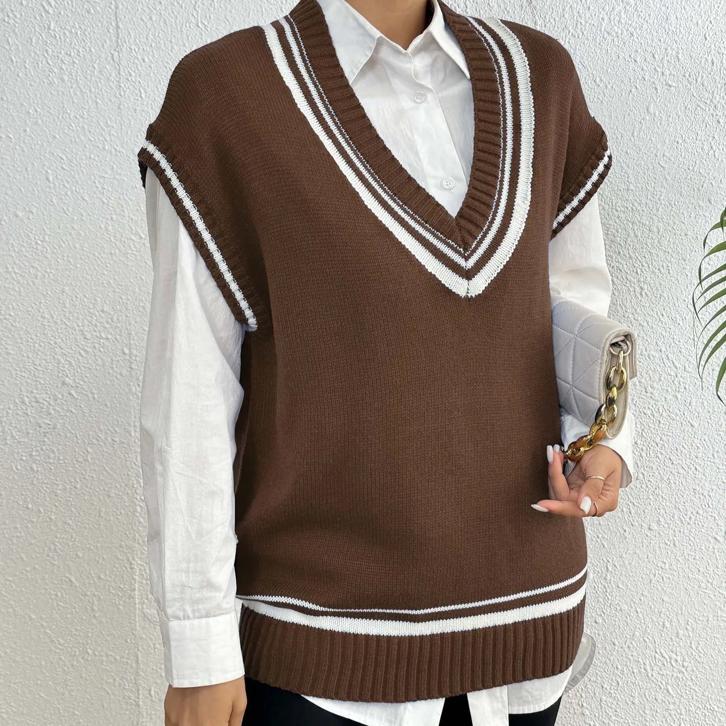 Women's loose fit pullover vest sweater in a college style, shown in blue.