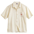 Light apricot men's Cuban collar shirt with an all-over bamboo and floral plant pattern print.
