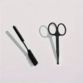 Black dual-ended pet grooming brush with soft silicone stain remover and plastic comb.