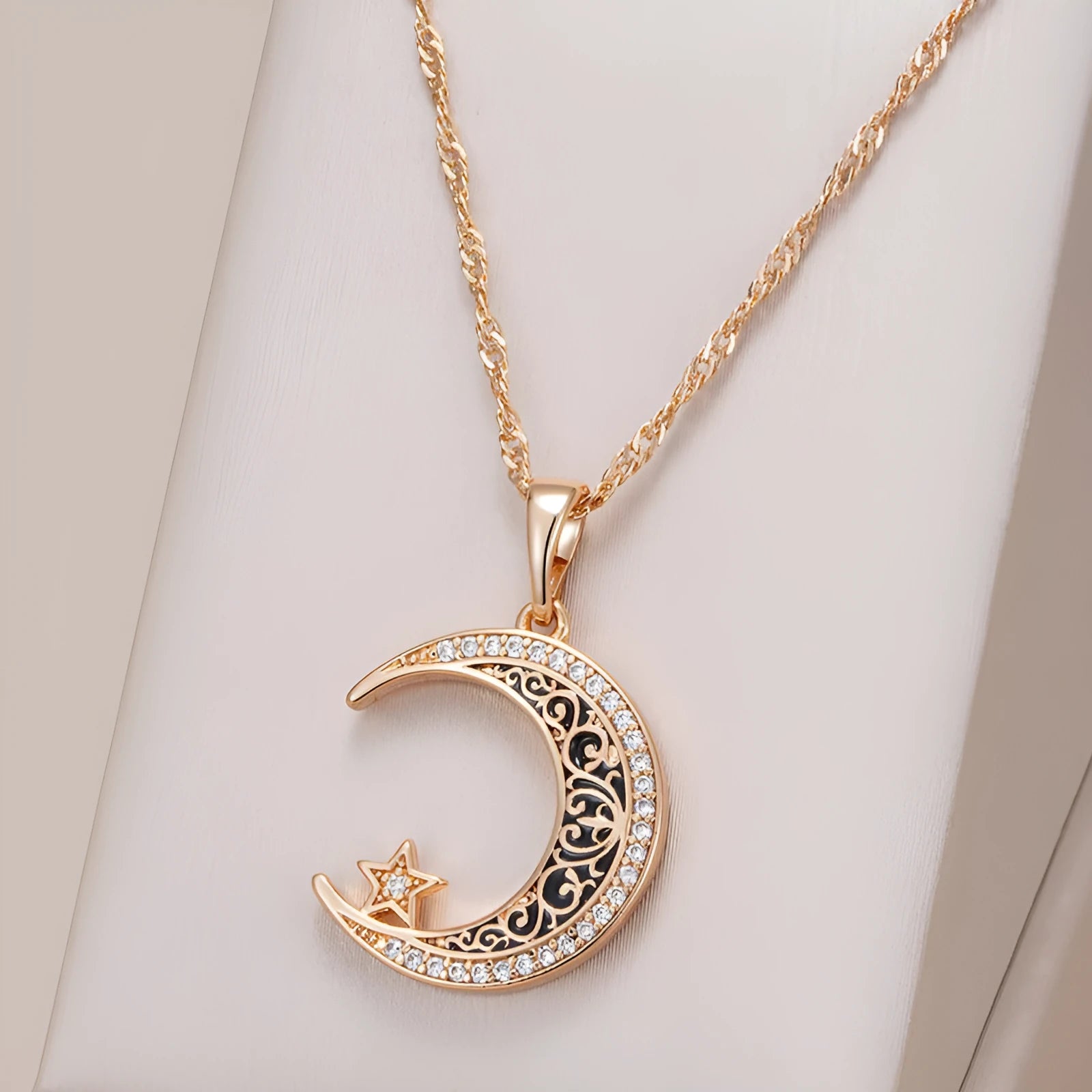 Rose gold star moon pendant necklace with zircon crystals and enamel detailing on water wave chain