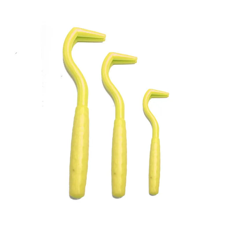 Three plastic tick hooks for dogs in various colours on white background