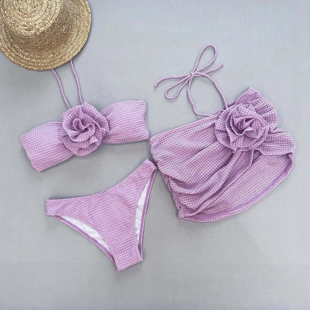 Women's white 3D flower split bikini set with skirt, bra, and briefs on a mannequin