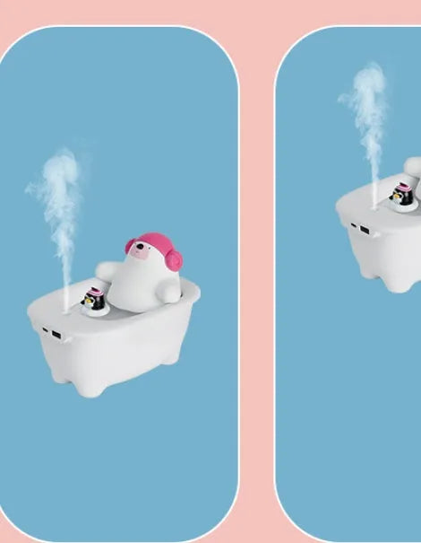 White USB air humidifier with large water tank on a desk next to a laptop.